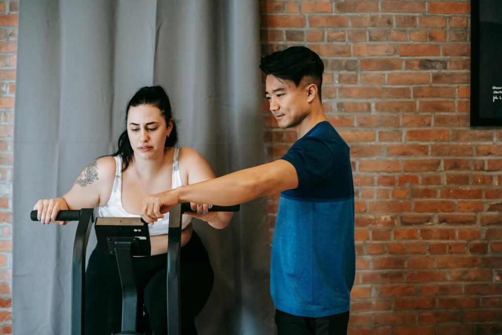 Man in his 40s on a video call with his Weight Loss Accountability Coach during a home workout.